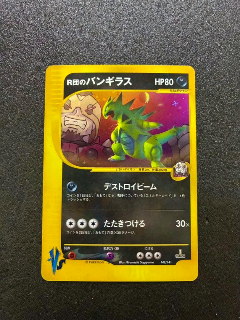 Photo of the R団のバンギラス Pokémon trading card (142/141 VS) showing the card front artwork and text on a black background.