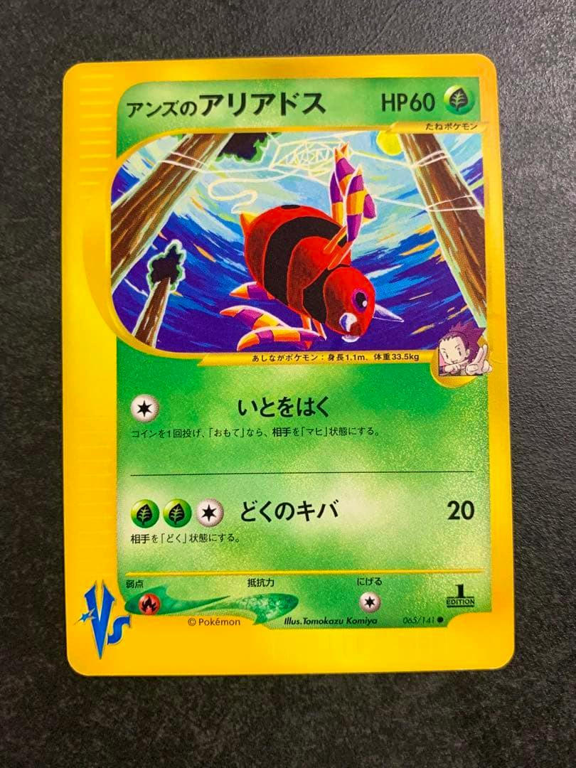 Front of the Japanese Pokémon trading card 'アンズのアリアドス' (065/141) showing the Ariados artwork, card text, and yellow border on a dark surface.