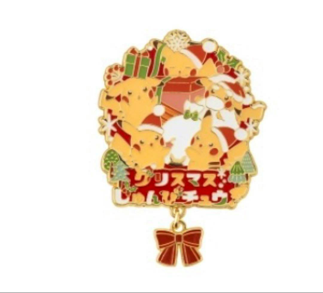 Photo of a Christmas-themed Pikachu logo pin showing multiple Pikachu wearing Santa hats with a dangling red bow charm.