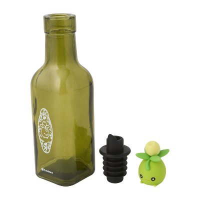 Green glass olive oil bottle shown with two stoppers, one black and one green Pokémon-themed stopper.
