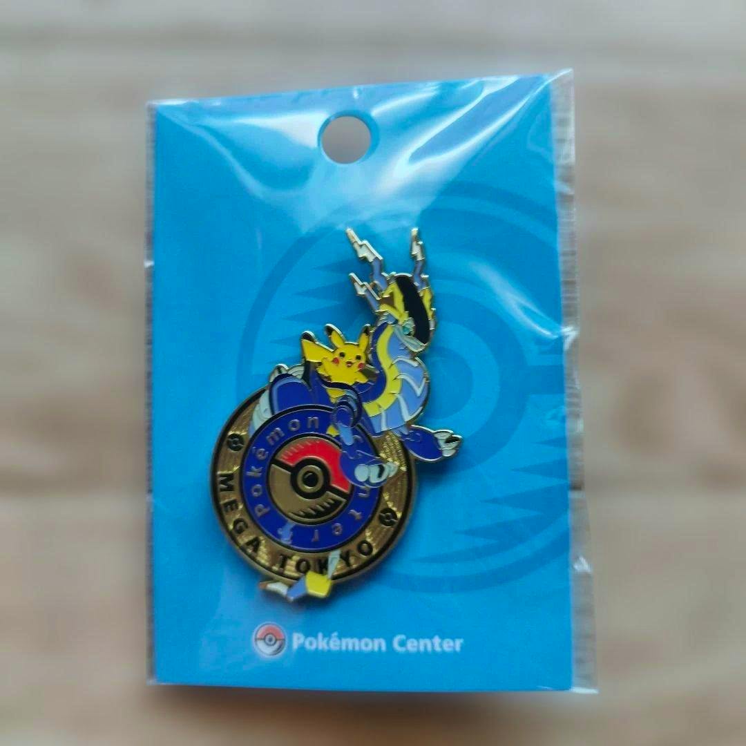 Front view of the Pokémon Center pin featuring Miraidon with Pikachu on a blue backing card inside plastic packaging.