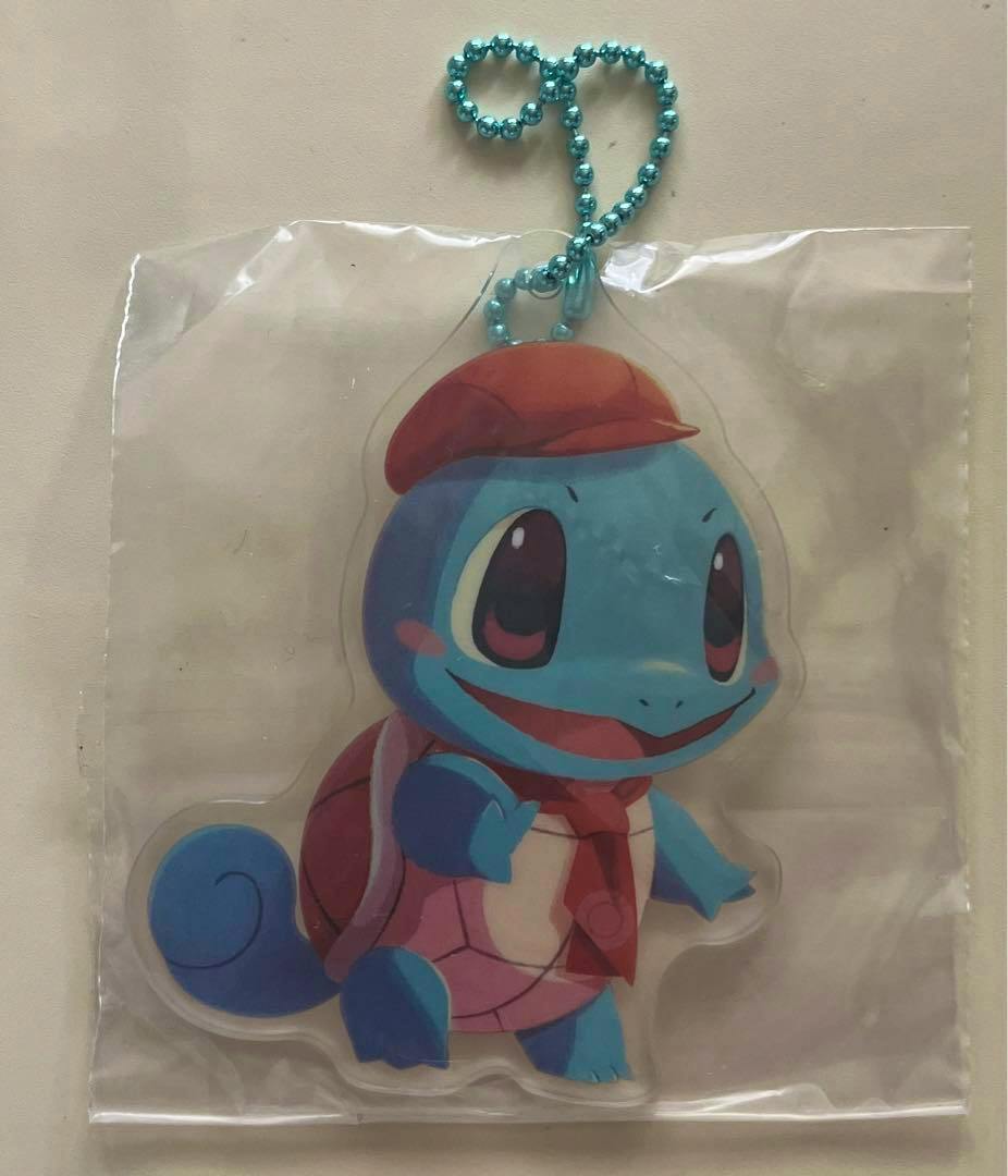 Sealed acrylic Squirtle (ゼニガメ) keychain with a blue ball chain shown inside a clear plastic bag.