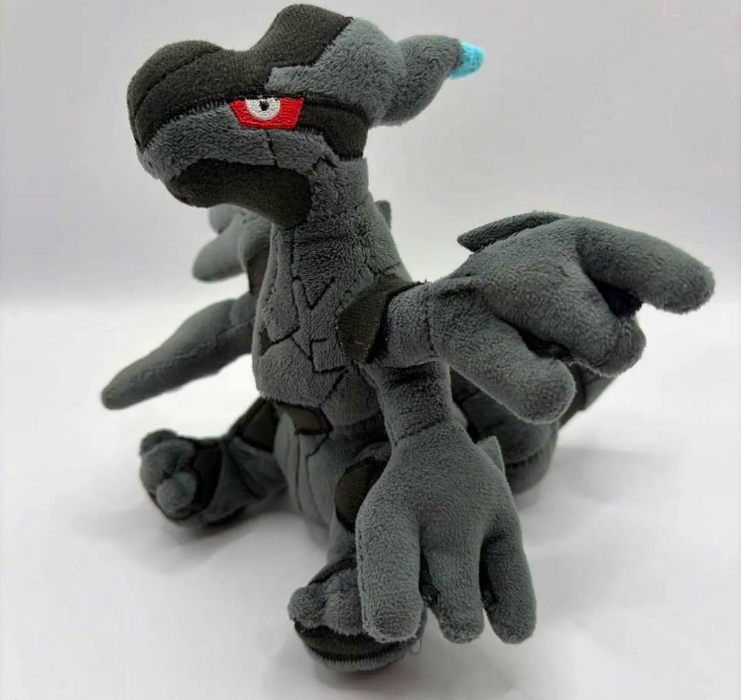 Three-quarter view of a gray Zekrom Pokémon Center plush toy on a white background.