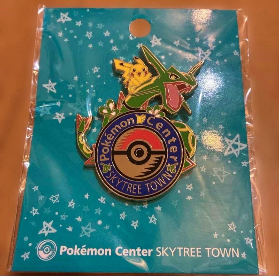 Front view of the Pokémon Center Skytree Town metal pin showing Rayquaza and Pikachu on a blue star-patterned backing card.