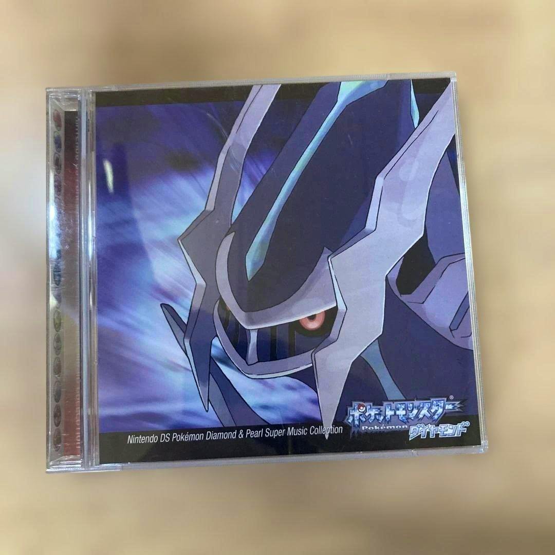 Front of the Pokémon Diamond & Pearl soundtrack CD case showing Dialga artwork and the title.