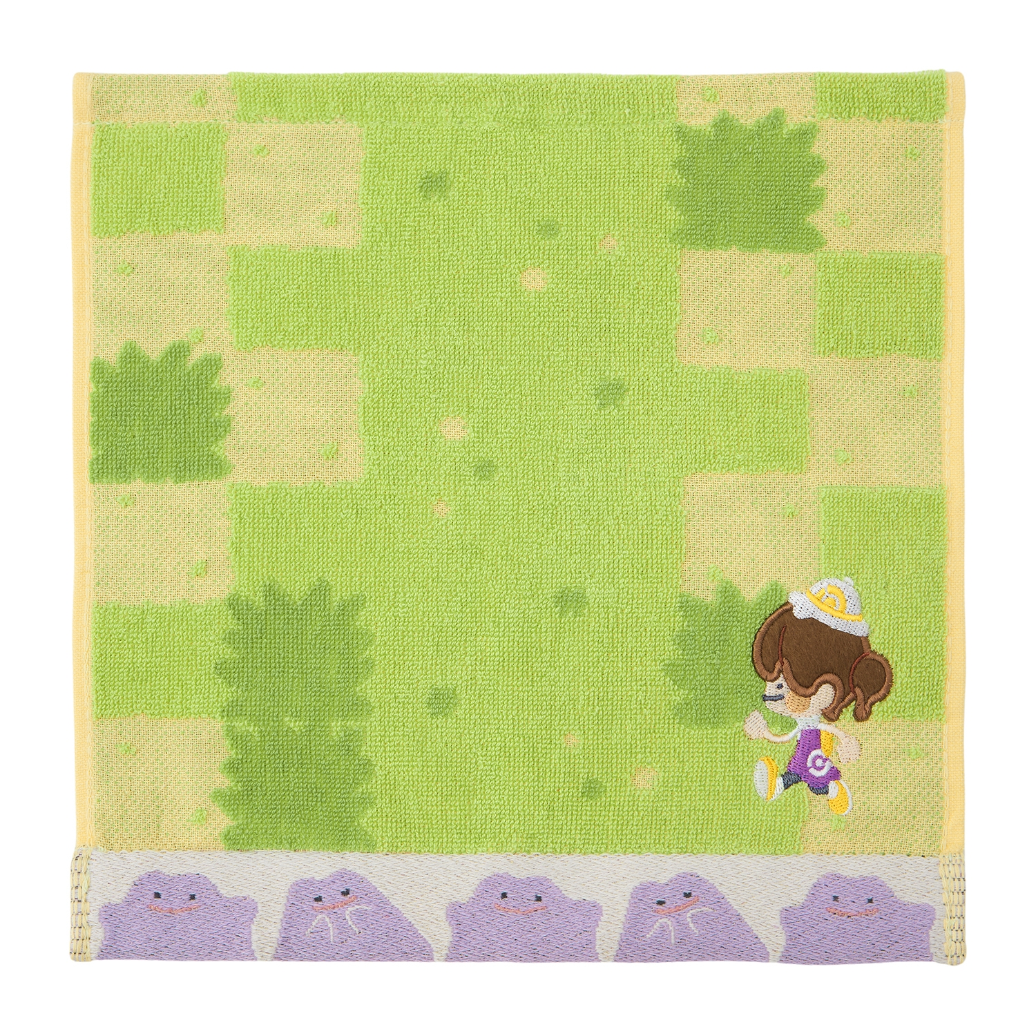 Green-and-yellow cotton handkerchief showing a small character and a row of purple Metamon faces along the bottom.