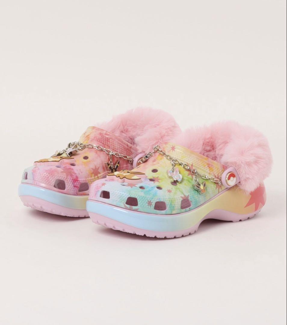 Pair of platform clogs with pink faux-fur lining, multicolor patterned uppers, and Eevee-themed charms.
