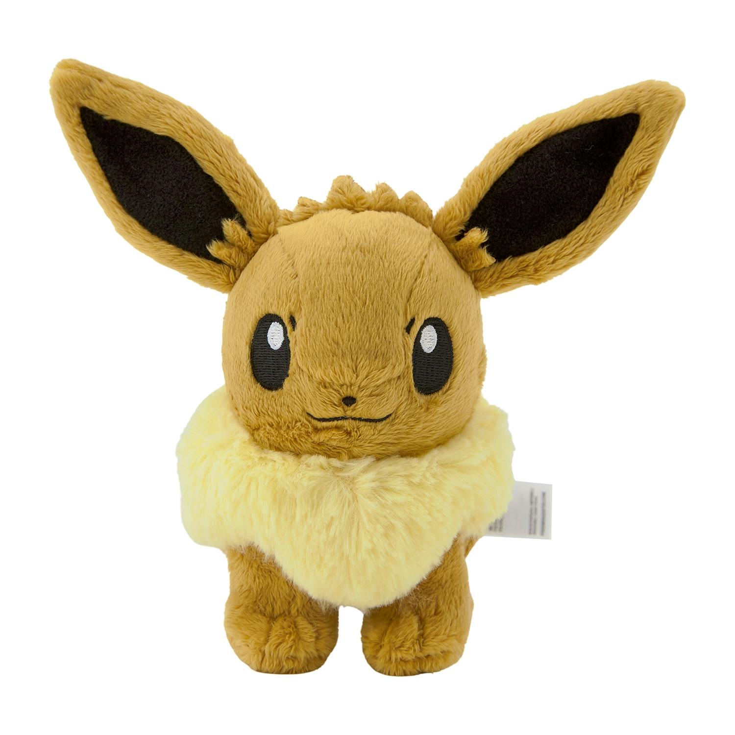 Front close-up of a standing Eevee plush toy showing its face, large ears, and fluffy collar.