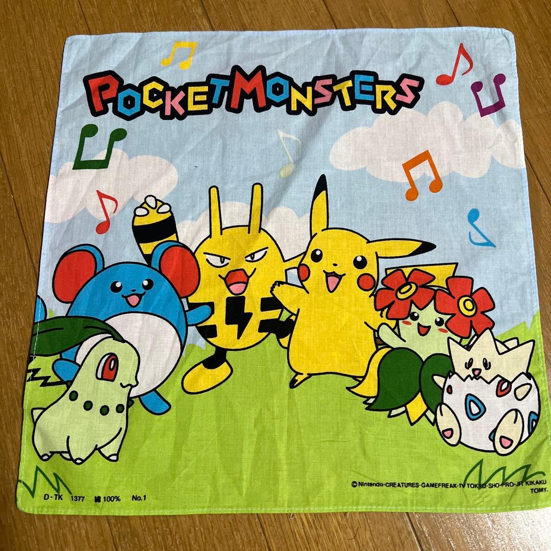 A Pocket Monsters (Pokémon) handkerchief showing Pikachu and other Pokémon characters on a blue sky and green grass background.
