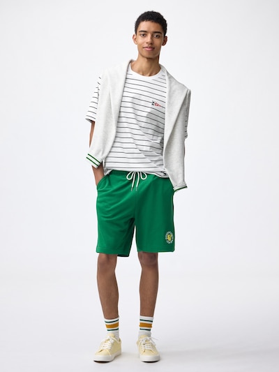 Model wearing the KIDS cotton lounge set showing the short-sleeve top and green shorts.