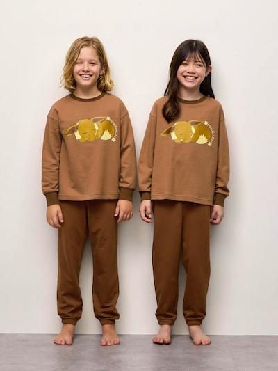 Two children wearing the brown cotton sweat lounge set with a sleeping Pokémon graphic on the sweatshirt.
