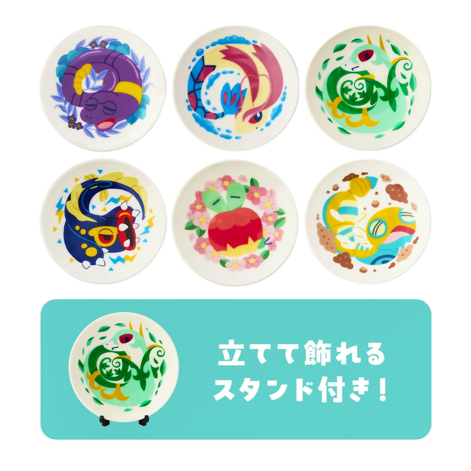 Photo of six small ceramic plates with colorful Pokémon character designs arranged in two rows, with a teal banner below showing one plate on a stand.