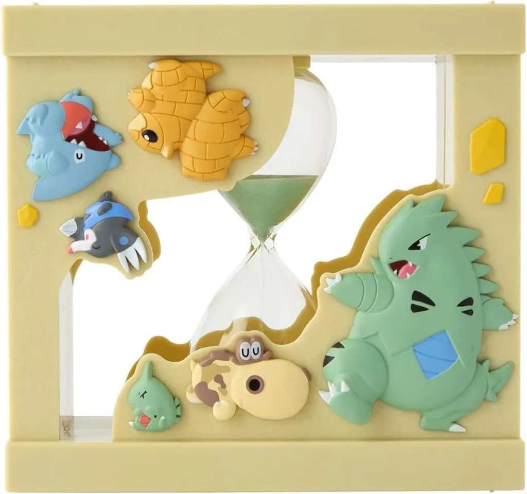 Front view of a Pokémon-themed hourglass (sand timer) with green sand and Pokémon character decorations on a beige frame.