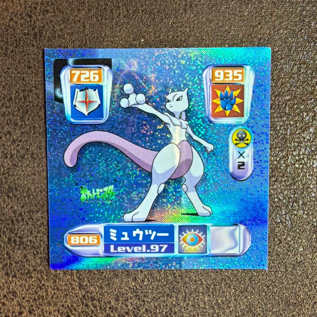 Holographic front of a Pokémon Mewtwo prism paper sticker showing Mewtwo artwork, numeric stats, and Japanese text.