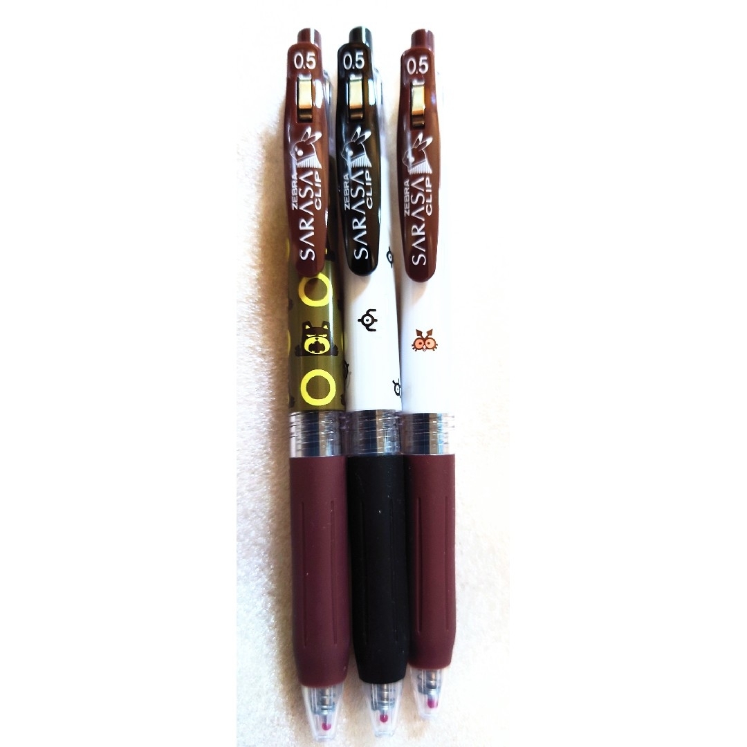 Three SARASA 0.5 ballpoint pens with different Pokémon-themed barrel designs on a white background.