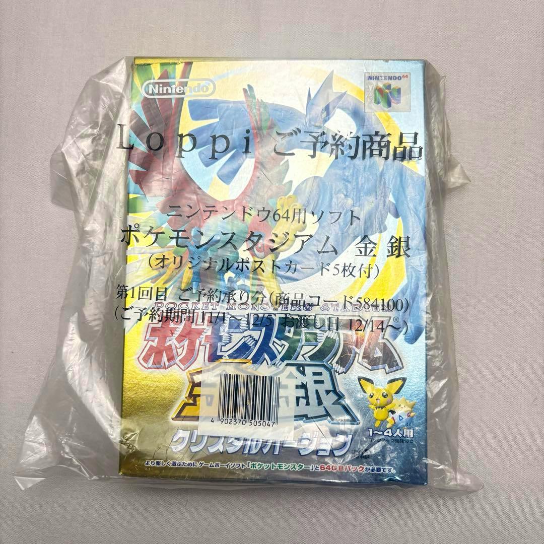 Front of the boxed Pokémon Stadium Gold/Silver Crystal version game in a clear plastic bag with Loppi reservation text and a barcode sticker visible.
