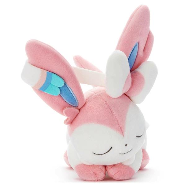 Pink and white Sylveon (ニンフィア) plush toy with closed eyes and ribbon-like ear decorations.