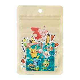 Beige resealable pouch displaying a Pokémon Timeless Adventure sticker set with several colorful stickers visible.