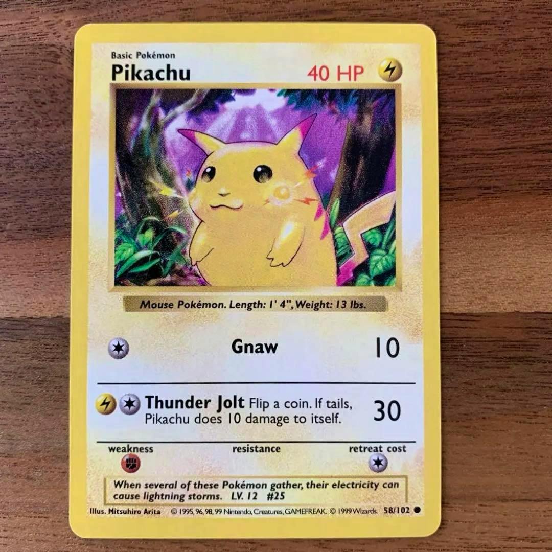 Front of the English 1999 Pikachu Pokémon trading card (CD promo) lying on a wooden surface.