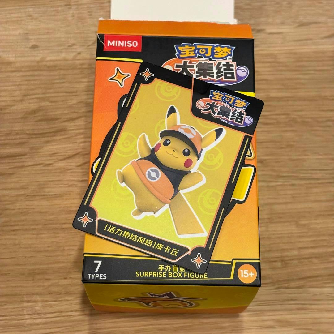 Packaged surprise box figure for Pokémon Unite featuring Pikachu shown on a branded Miniso box with a character card on top.