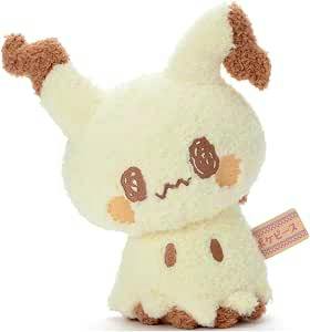 A cream-colored Mimikyu plush toy with brown accents and a fabric tag, photographed on a white background.