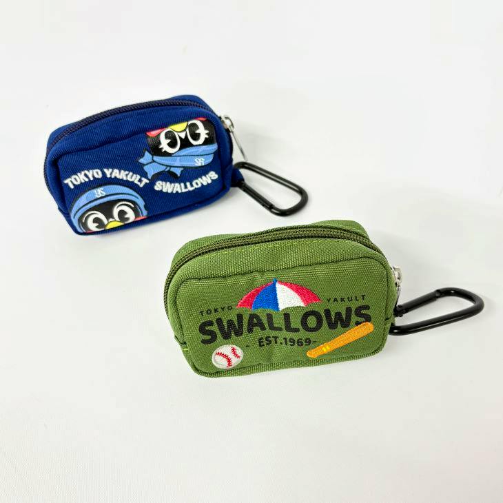 Two small polyester golf ball pouches with carabiners, one green and one blue, shown on a white background.