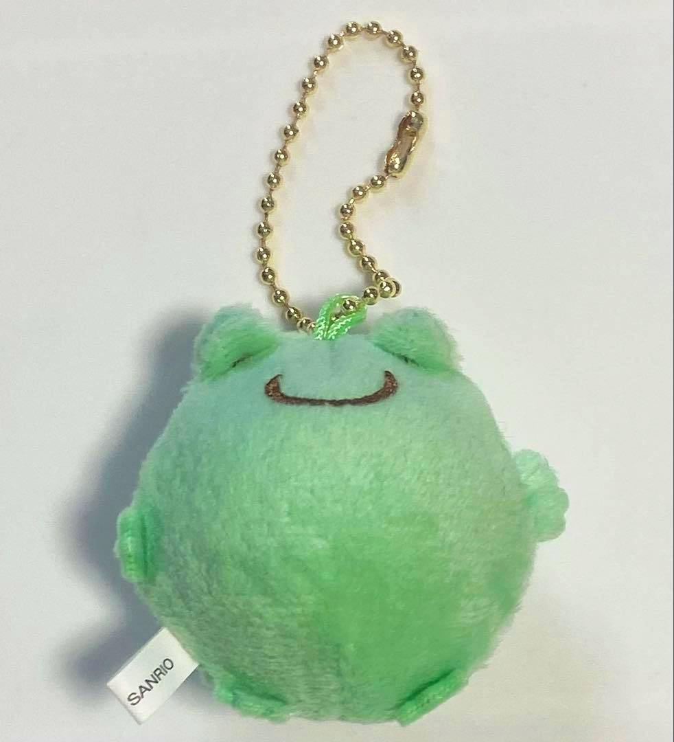 Mint-green round Pom Pom Purin plush keychain with a gold ball chain and a Sanrio tag visible.
