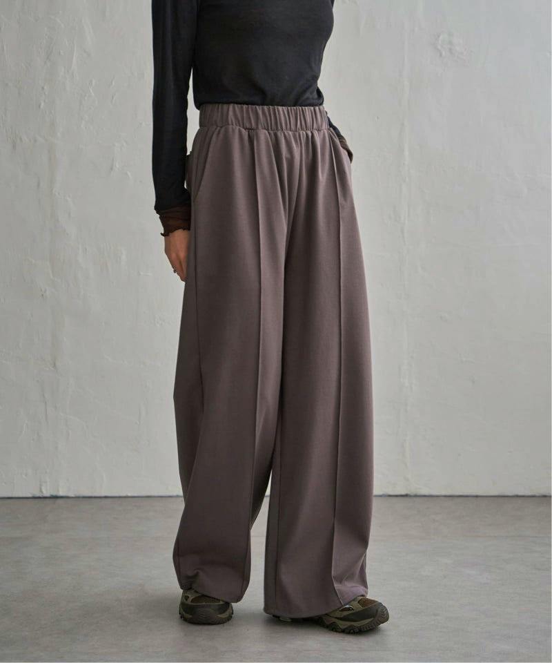 A model wearing the women's cotton wide-leg elastic-waist pants in brown, shown from waist to shoes.
