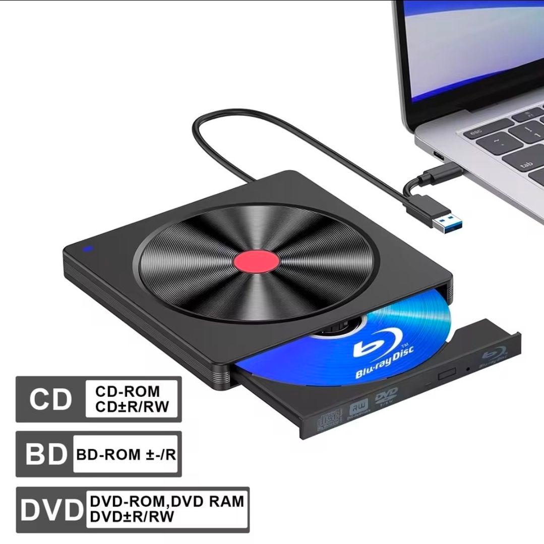 Portable external Blu-ray disc drive connected to a laptop via USB with a Blu-ray disc partially ejected.