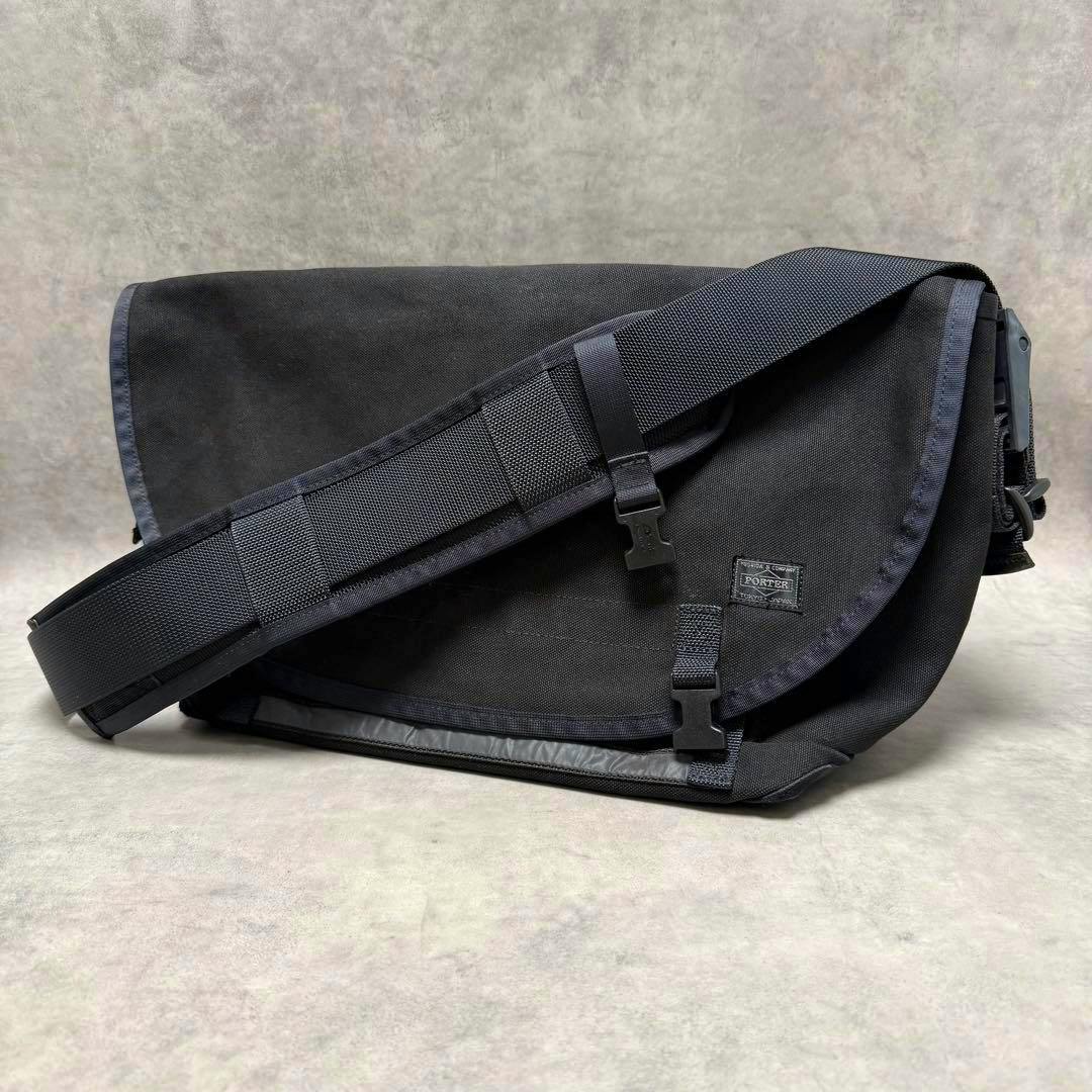 Black PORTER messenger bag in polyester with a flap and adjustable shoulder strap on a neutral background.