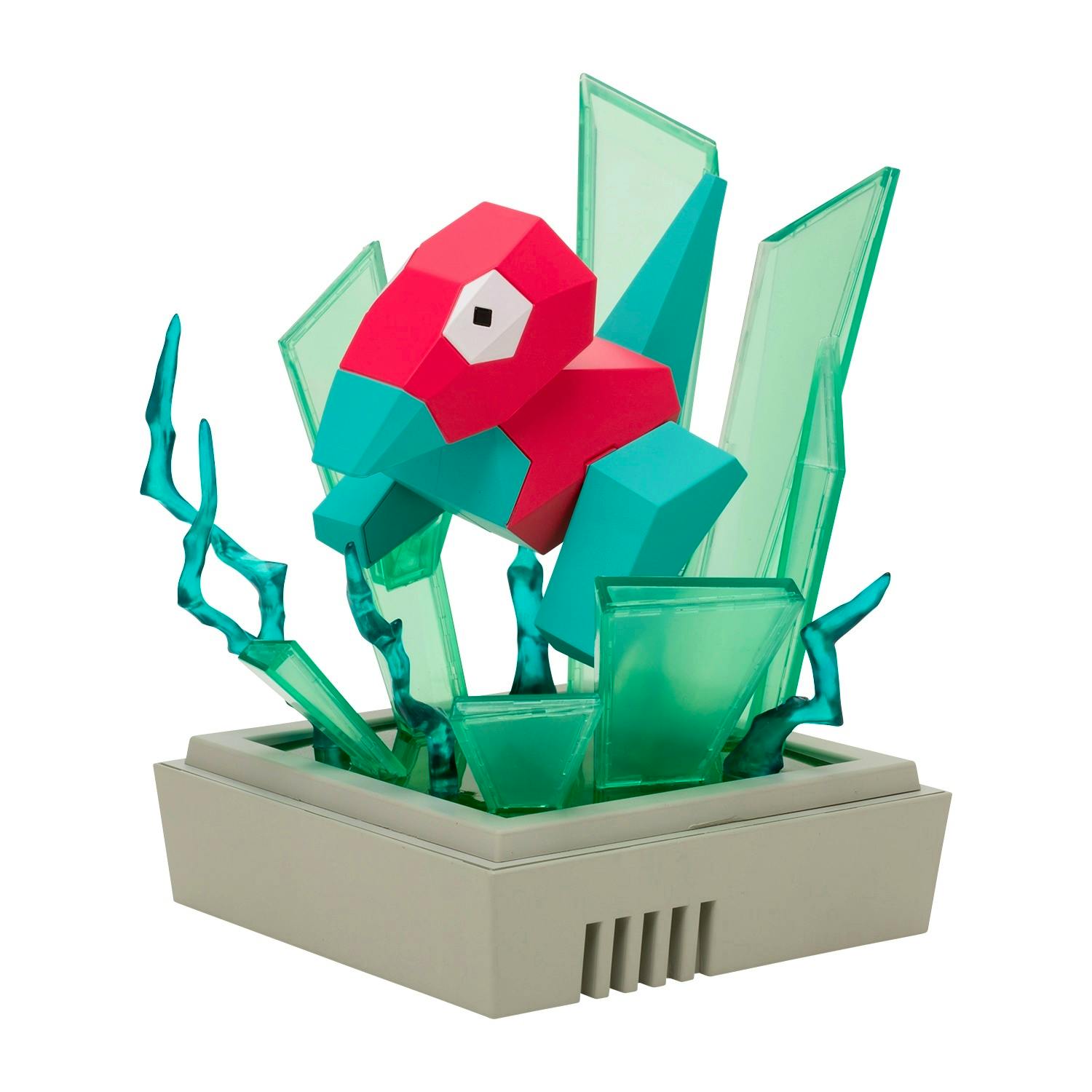 A polygon-style Porygon plastic figure with green translucent crystal-effect pieces mounted on a beige display base.