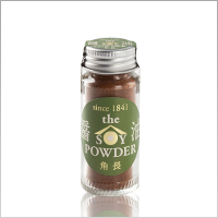 Studio photo of a small glass jar of powdered soy sauce with a green label reading "the POWDER" and a metal screw cap.