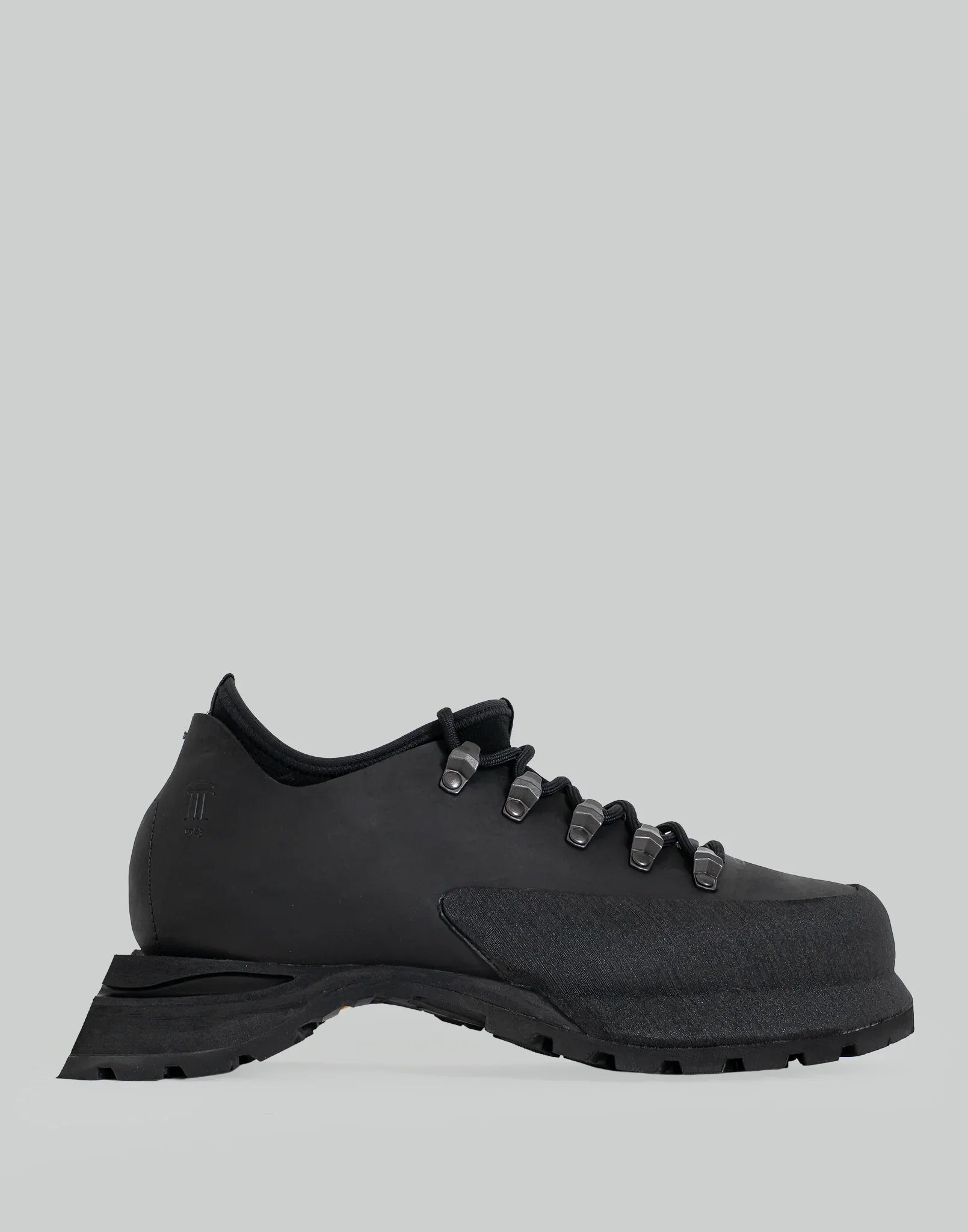 Side view of a black leather POYANA boot on a plain gray background.