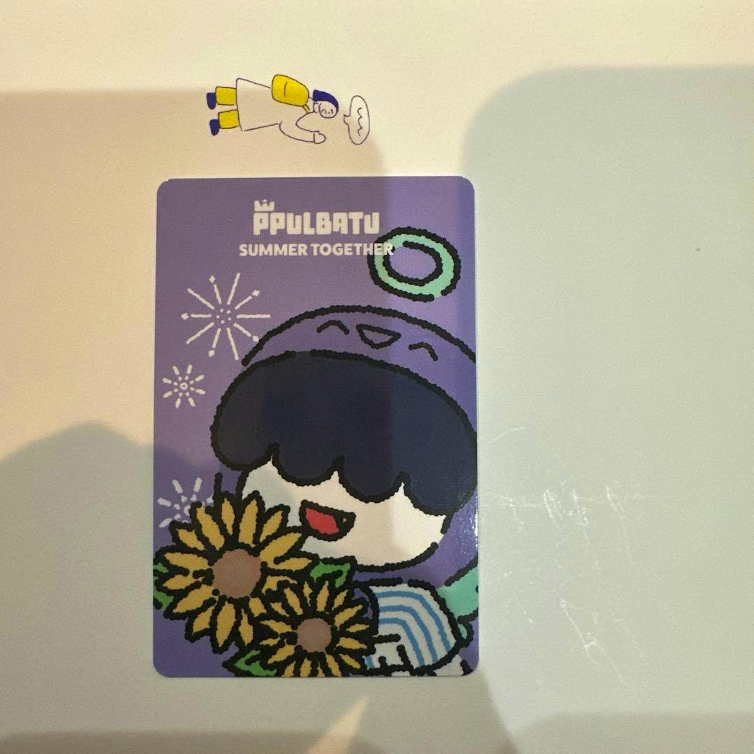 Photocard showing a purple illustrated character holding sunflowers with the text “PPULBATU SUMMER TOGETHER”.