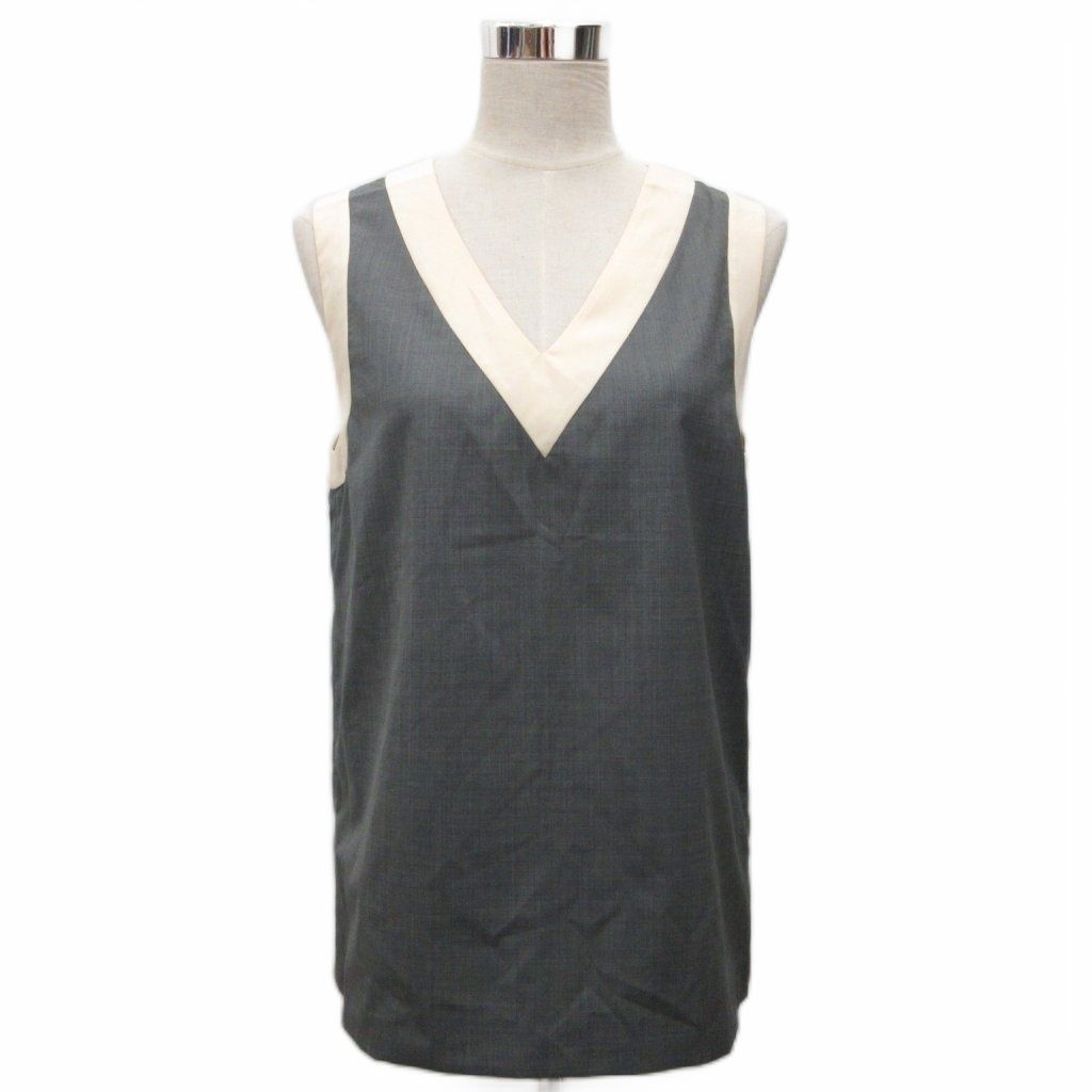 Grey and beige V-neck sleeveless women's blouse displayed on a mannequin.