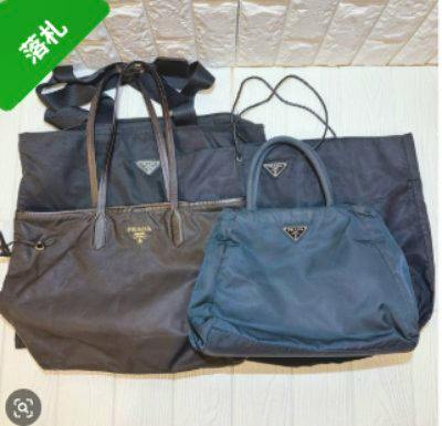 Four nylon Prada bags, including a tote and a handbag, laid flat with visible triangular logo plates.