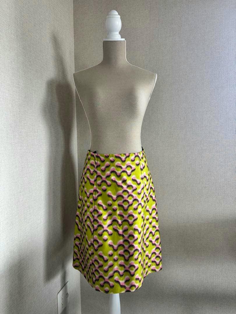 Mannequin wearing a green and pink patterned Prada flared skirt.
