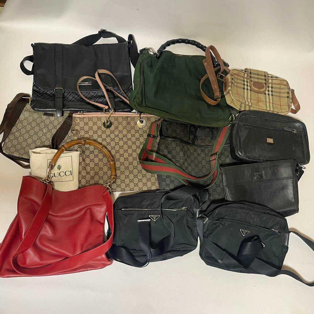 Multiple handbags and shoulder bags laid flat on a white background, showing a mix of monogram, leather, and nylon styles.
