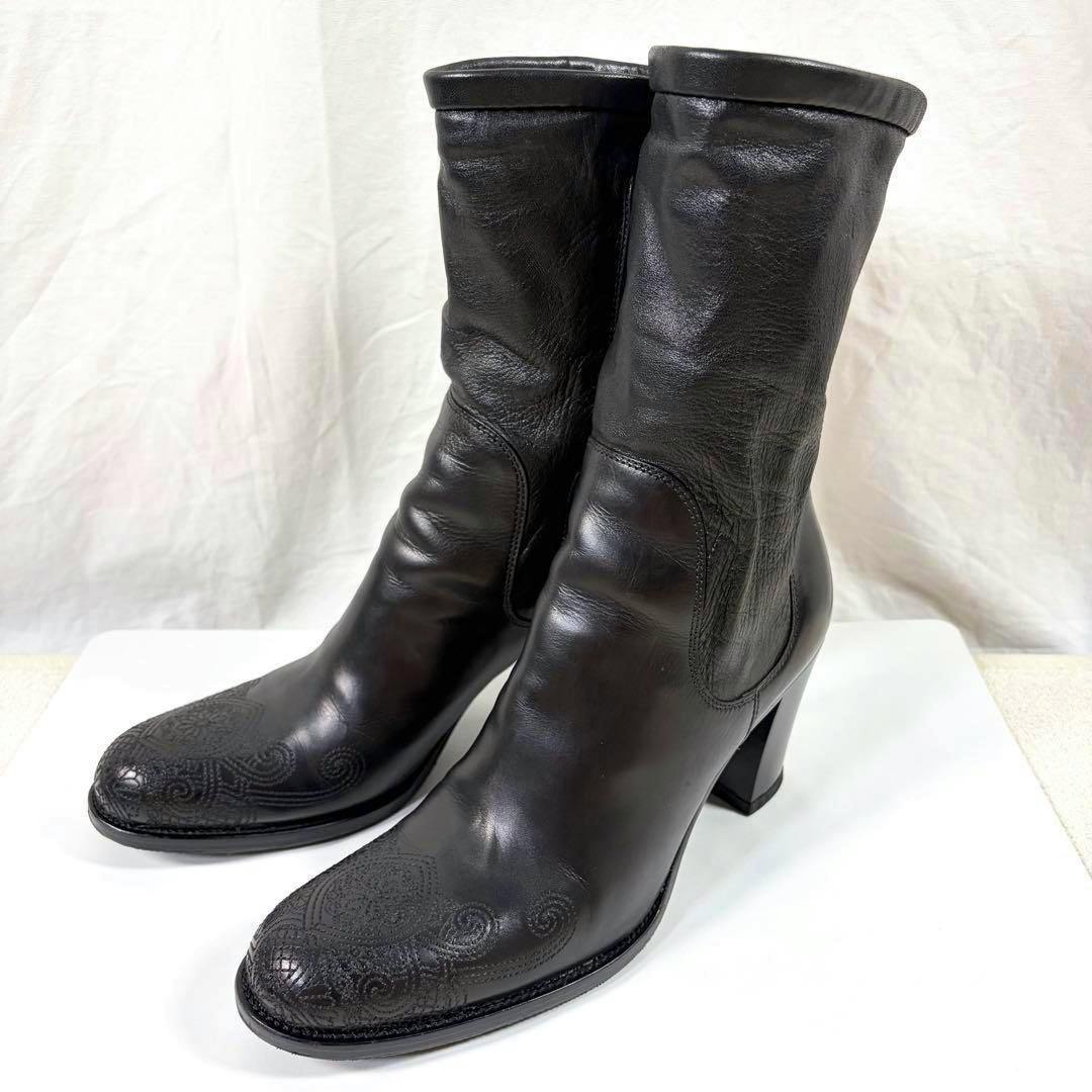 Black leather Prada short boots shown from a three-quarter angle on a white background.