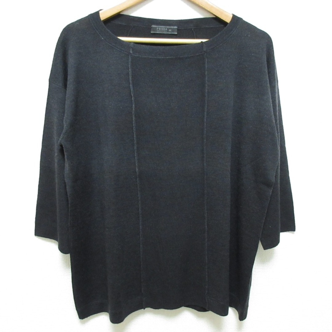 Front view of a black PRADA half-sleeve silk-blend knit sweater on a hanger.