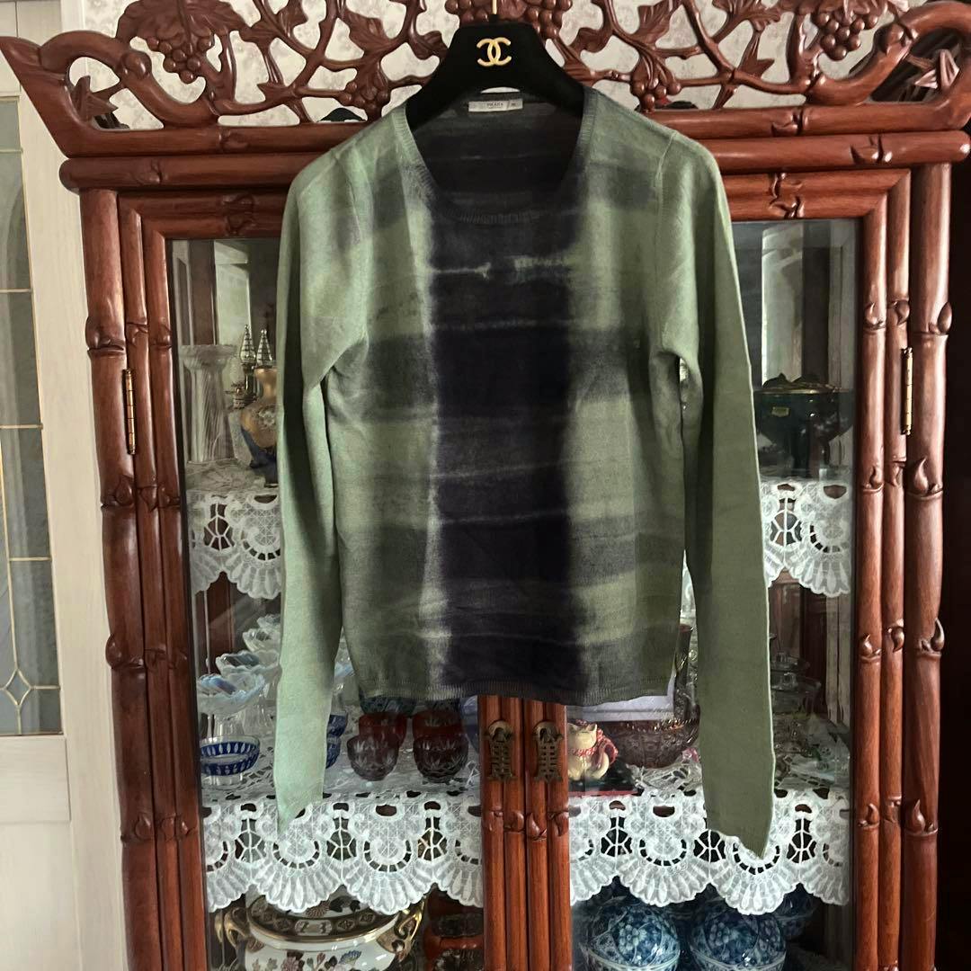 Green-toned long-sleeve knit sweater (PRADA, size 38) hanging on a hanger, front view.