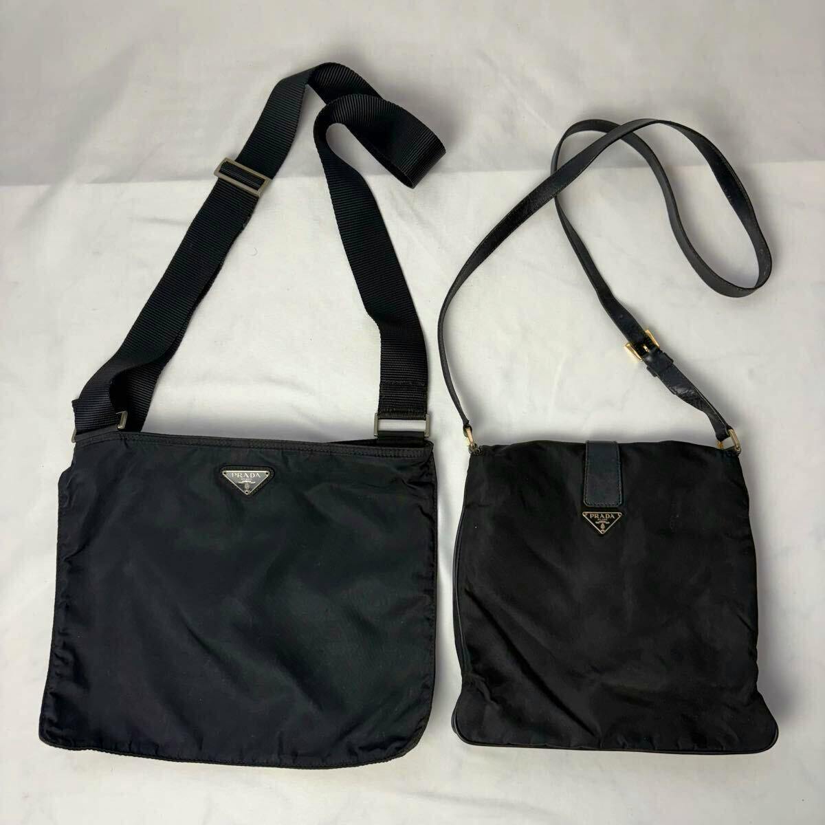 Two black PRADA nylon shoulder bags with triangular logo badges laid flat on a white background.