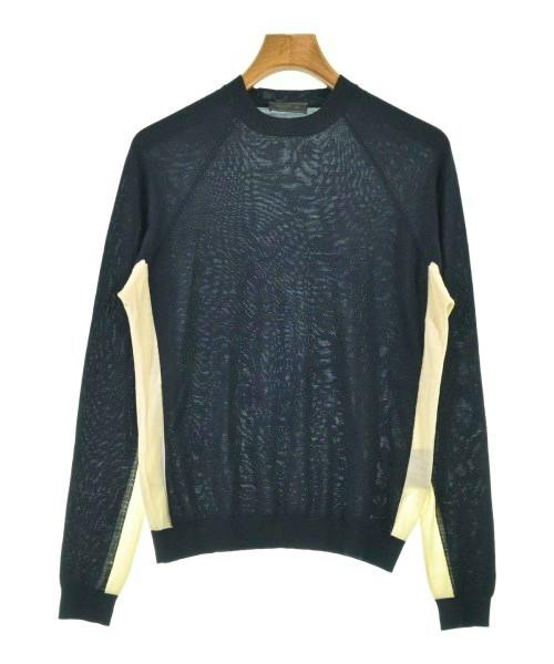 Front view of a black Prada wool sweater with cream side panels hanging on a wooden hanger.