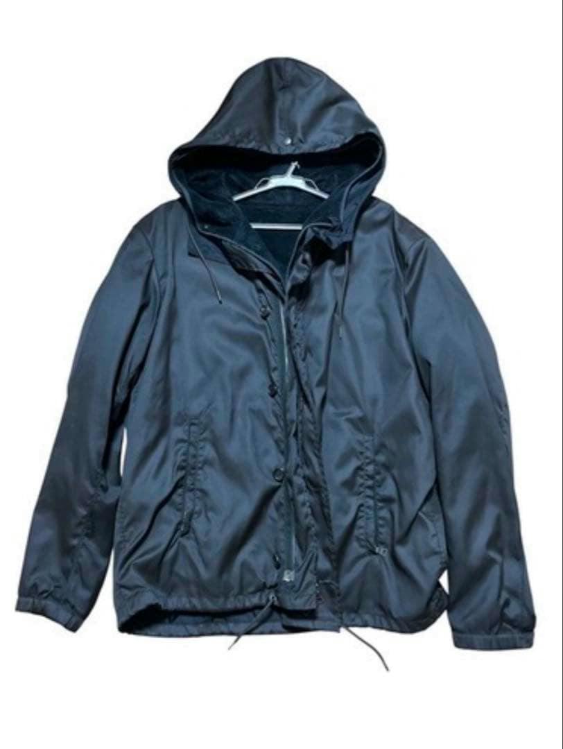 Black Prada zip-up nylon men's jacket with a hood displayed on a hanger.