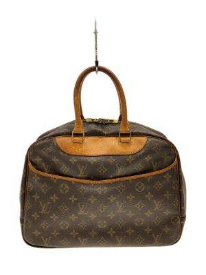 A Louis Vuitton monogram canvas bowling-style vanity bag with brown leather handles shown from the front.