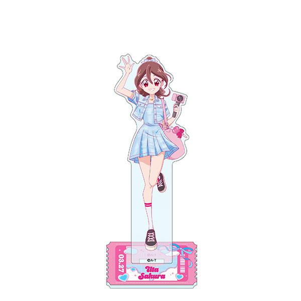 A front-facing photo of the Precure Travel acrylic decorative stand showing the Uta Sakura character figure attached to its printed rectangular base.