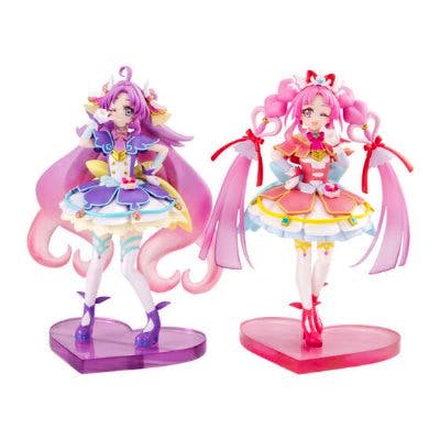 Two plastic Precure figures posed on heart-shaped bases against a white background.