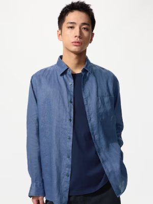 Male model wearing a blue linen button-up shirt against a white background.