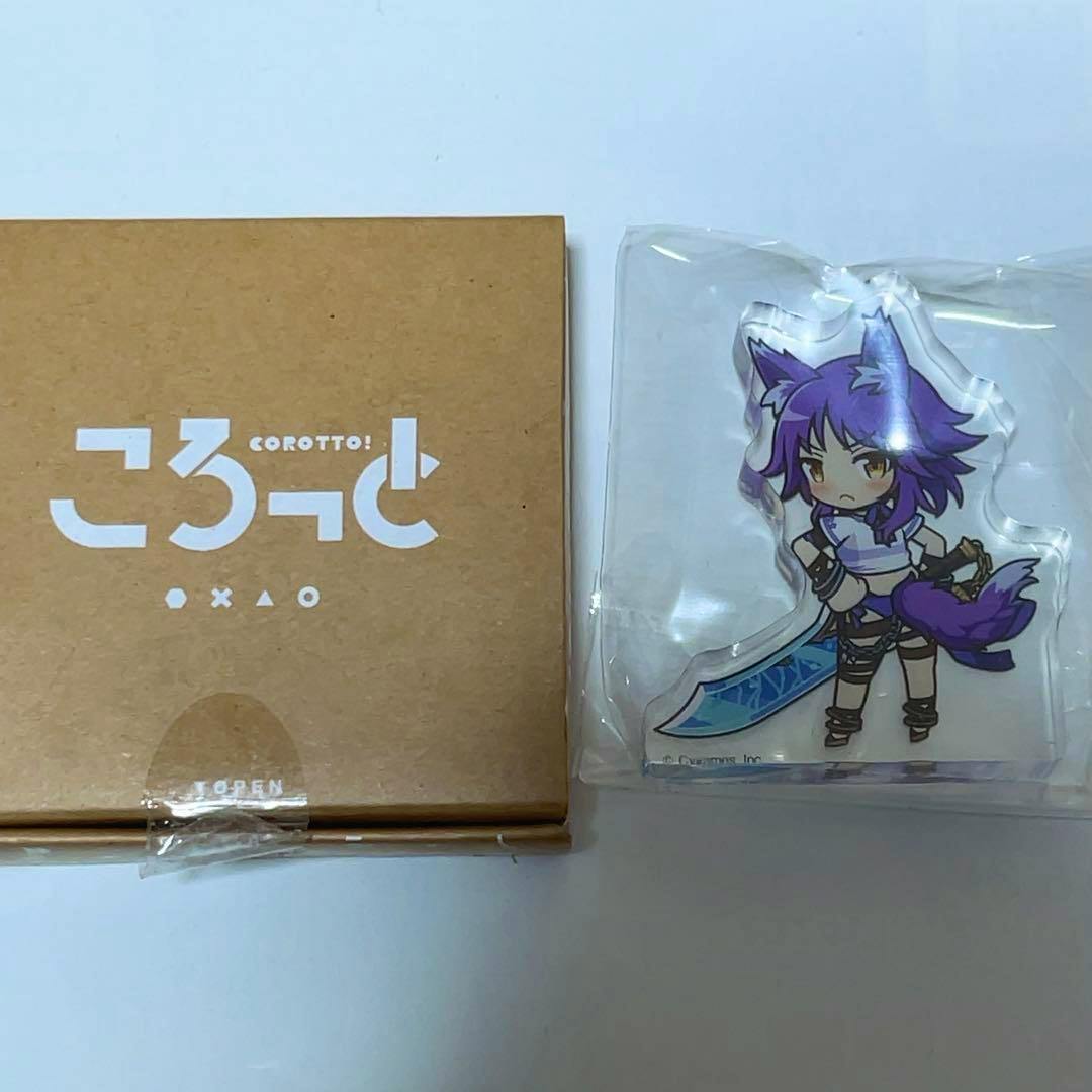 Cardboard product box next to a plastic-wrapped acrylic stand showing a purple-haired chibi character from the Princess Connect acrylic figure collection.