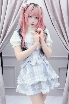 Model wearing the Ice Blue "Princess Melody" double ribbon check pattern corset-style camisole dress, shown full-length against a curtained backdrop.